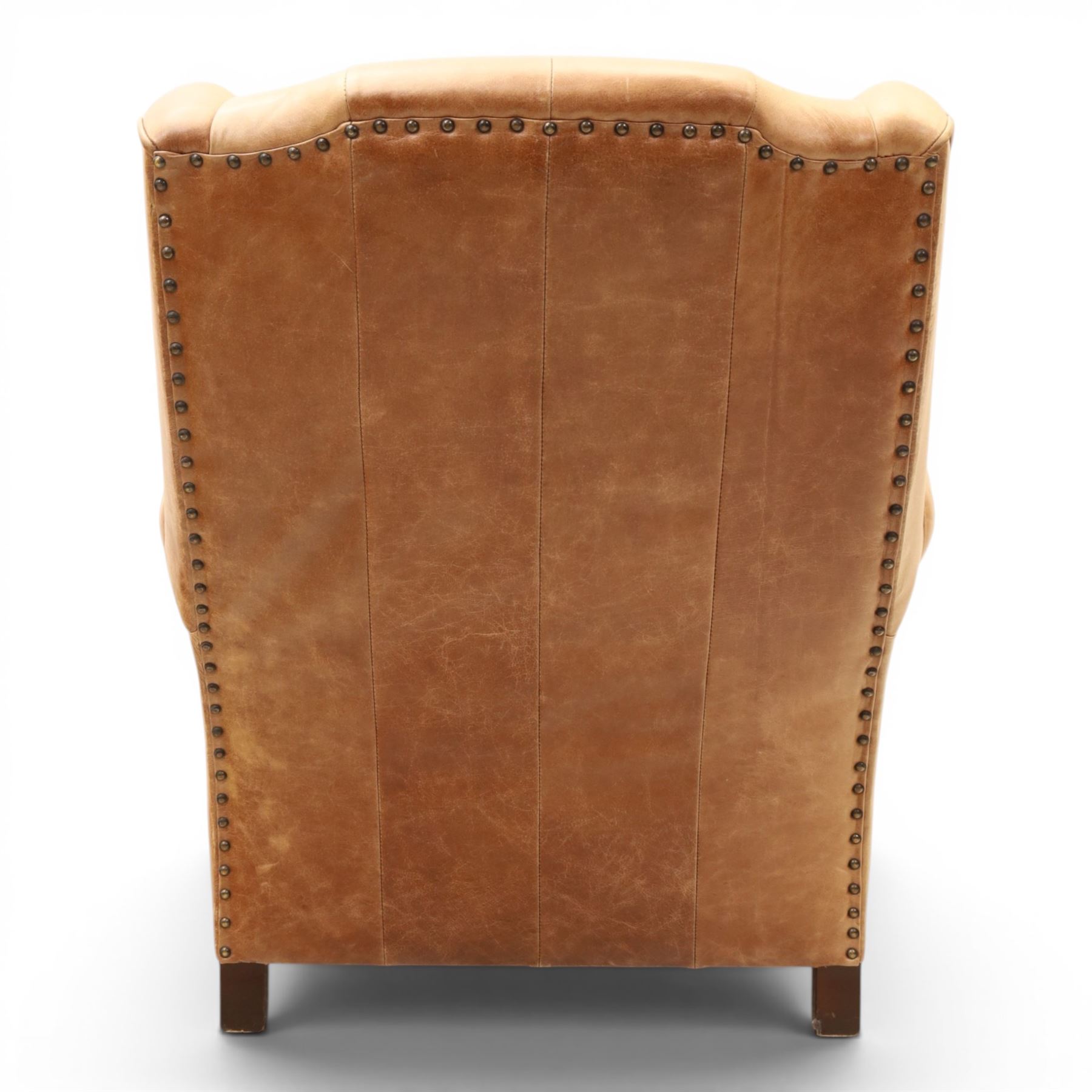 TETRAD for John Lewis - brown leather upholstered wingback armchair, button back with diamond tufted detail, loose seat cushion with piped edge, scroll arms and padded side wings, on short supports
