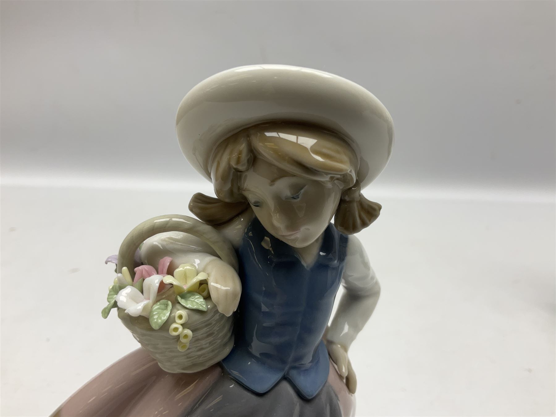 Three Lladro Flower Girls figures, comprising Sweet Scent no 5221, Pretty Pickings no 5222 and Spring is Here no 5223, largest example H18cm 