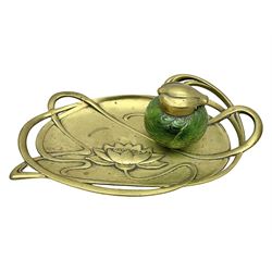 Art Nouveau Geschutzt brass desk stand, with stylised whiplash relief decoration, with removable Loetz style green glass inkwell, stamped to the base, H8cm