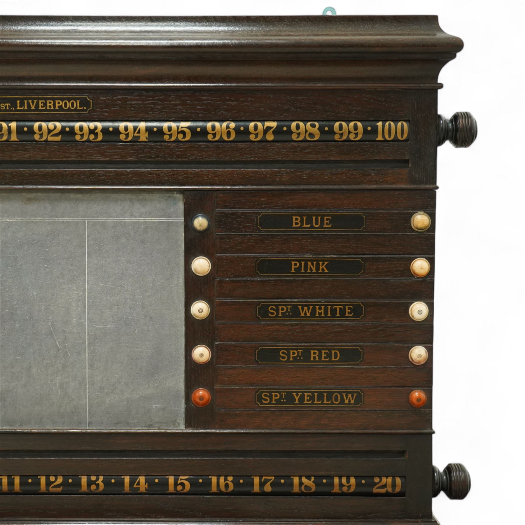 Victorian wall-mounted oak and walnut cased scoreboard,  moulded top, with a name stencilled in the frieze ‘J. Ashcroft, Victoria Street, Liverpool’, the board with chalk panel in the centre for recording scores, sliding panels on both sides for the various games of Billiards and Snooker, two numbered rotating arms with adjustable sliding score keepers, the base section with 5 apertures on each side, and coloured ivory roundels, all with glass front for viewing the tokens inside, with drawers beneath, the centre has a long glass panel for storing billiard balls, circa 1870 This item has been registered for sale under section 10 of the APHA Ivory Act Reference UNEGEBLB
