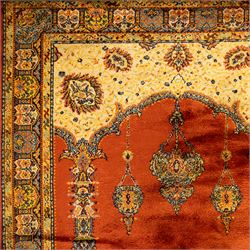 Persian Kashan prayer rug, rust red field with mihrab arch design, suspended floral hanging lamps, and a central flowering vase framed by columnar supports enclosed by palmette and meandering vine border