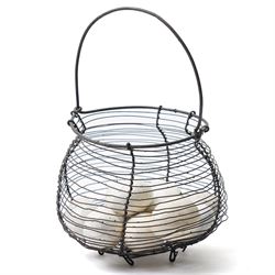 Wire crock containing11 broody hen ceramic dummy eggs, two marked 'Caperns'