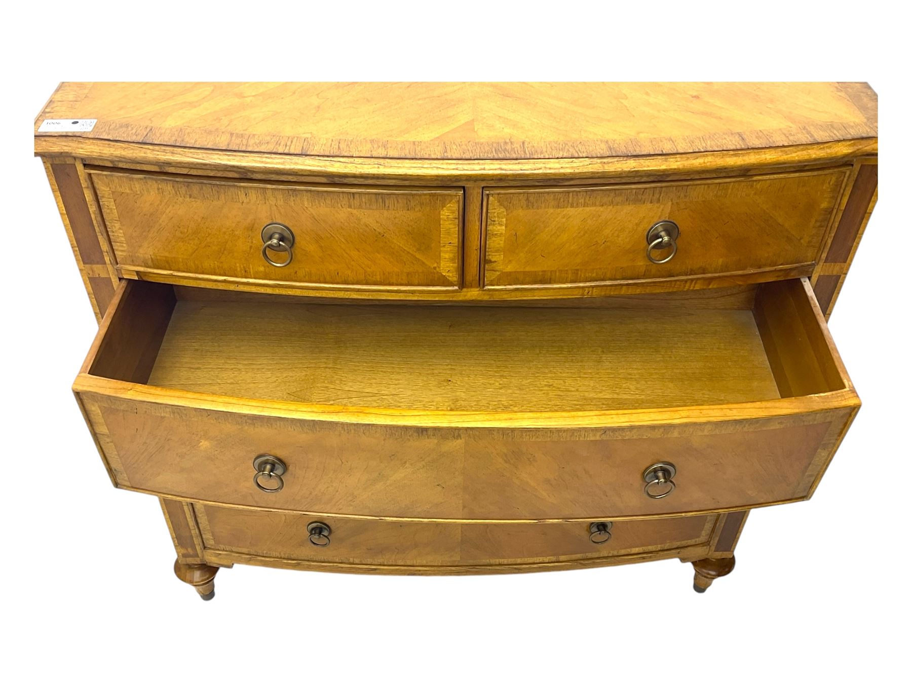 Frank Hudson - mid-20th century Mindi ash and burr walnut 'Spire' bow-fronted chest, featuring a crossbanded top over two short and three long cockbeaded drawers, raised on turned supports  