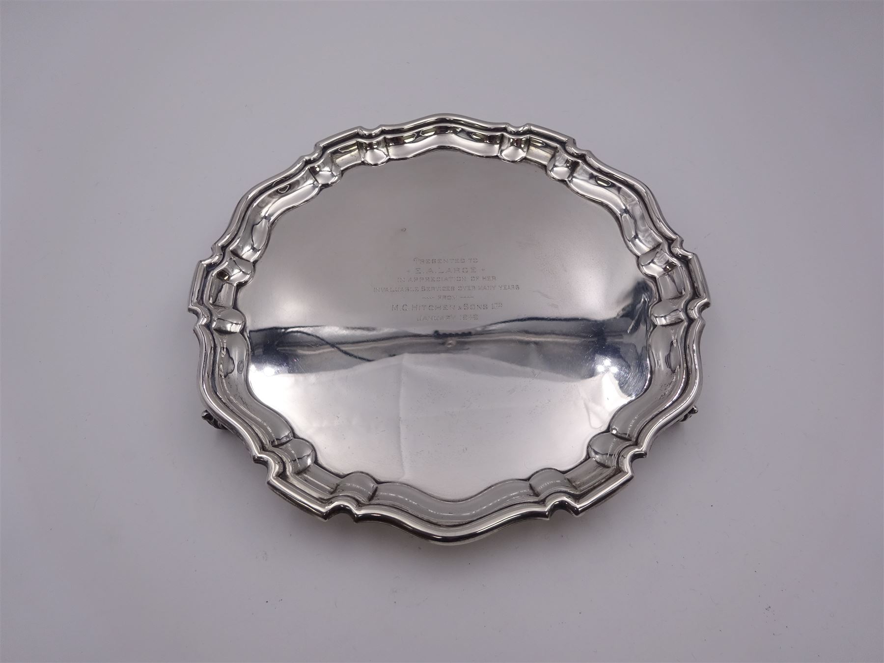 1940's silver waiter, of circular form with Chippendale type rim and personal engraving to centre, upon three scroll feet, hallmarked William Suckling Ltd, Birmingham 1934, D20cm, approximate weight 10.70 ozt (332.9 grams)