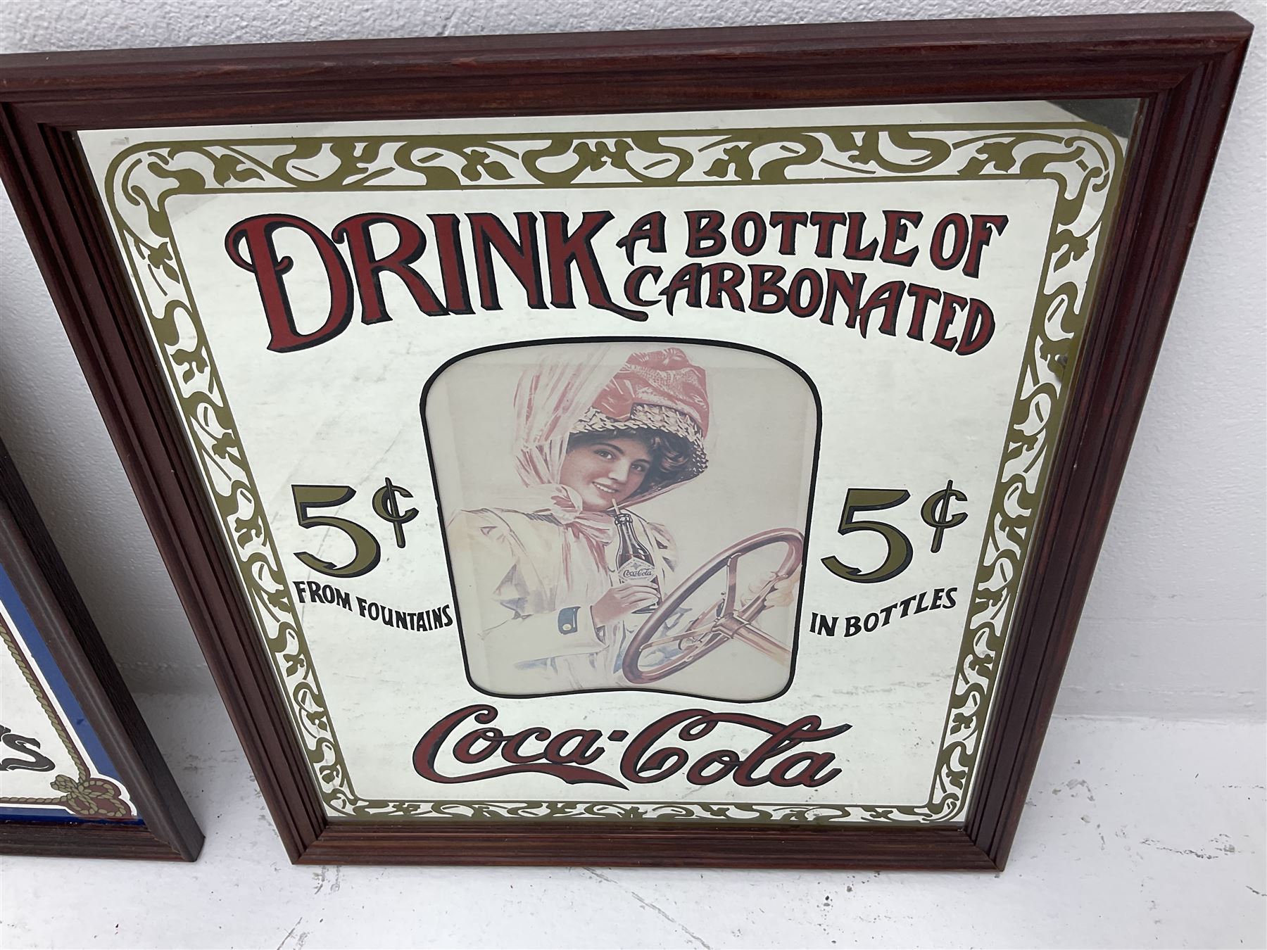 Four advertising mirrors, comprising of Southern Comfort, All Ranks smoke Marcella Cigars, Coca-Cola and Player's Navy Cut, largest example H70cm, L60.5cm