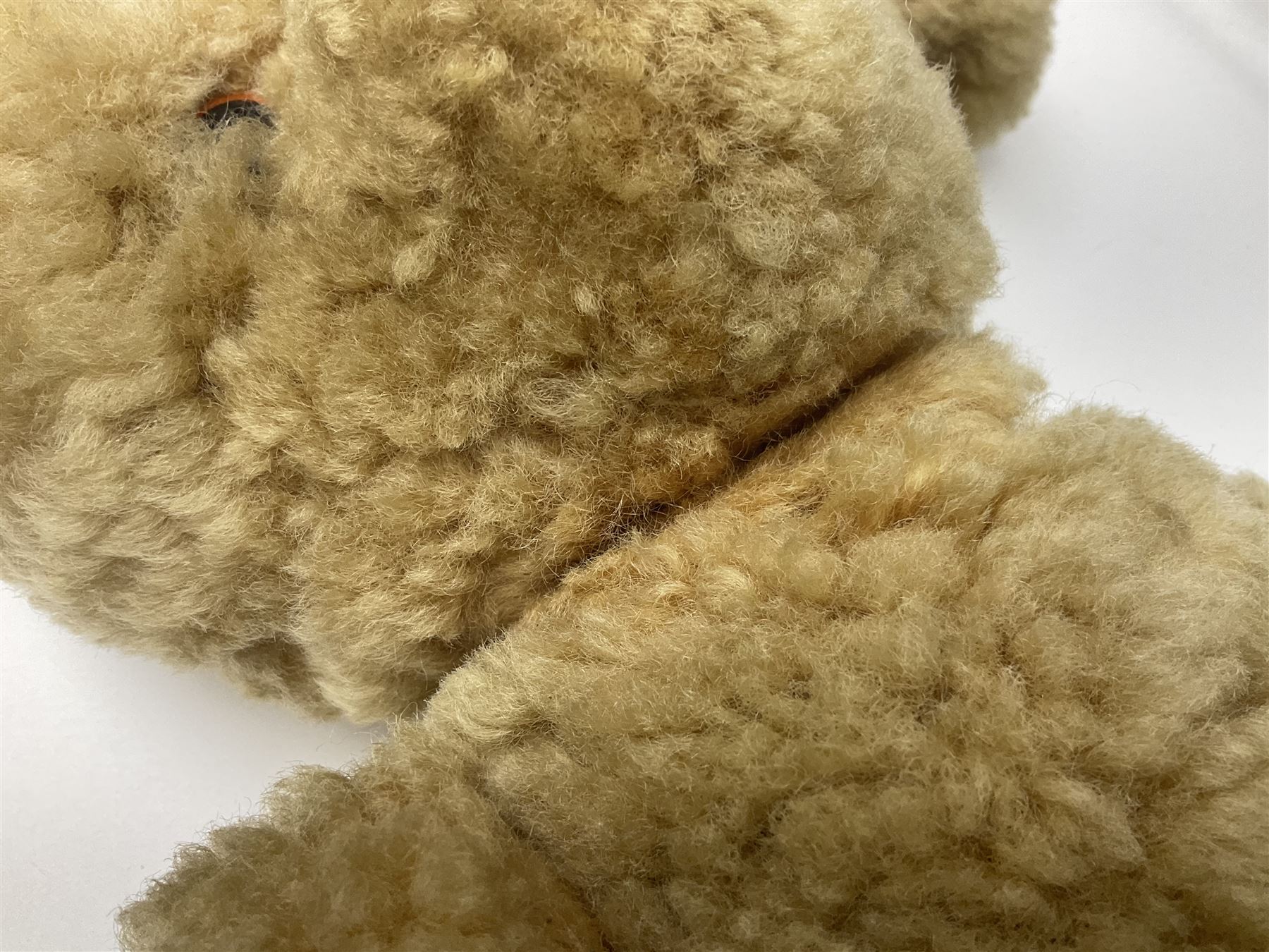 1950s sheepskin plush covered teddy bear with musical movement, the revolving head with applied eyes, leather nose and stitched mouth, jointed limbs with leather pads H50cm