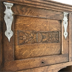 Arts and Crafts period oak sideboard, raised triple shaped arch top fitted with cupboard, rectangular top over three drawers and two cupboards, panelled doors relief carved with foliate urn, turned supports, ivorine label to door interior inscribed 'J. K Thomson... Falkirk', W151cm, H159cm, D53cm