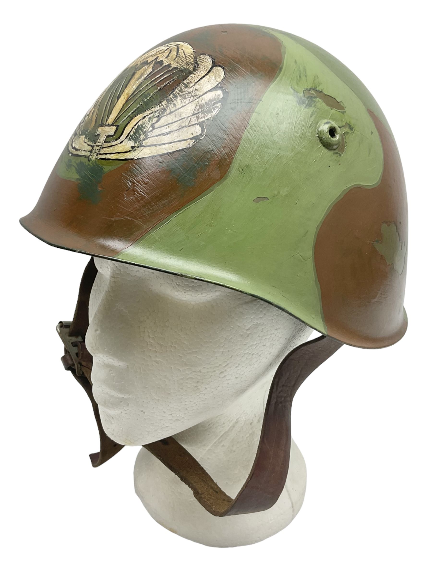 1960s Italian parachutist helmet with liner; camouflage paintwork with parachutist crest to the front