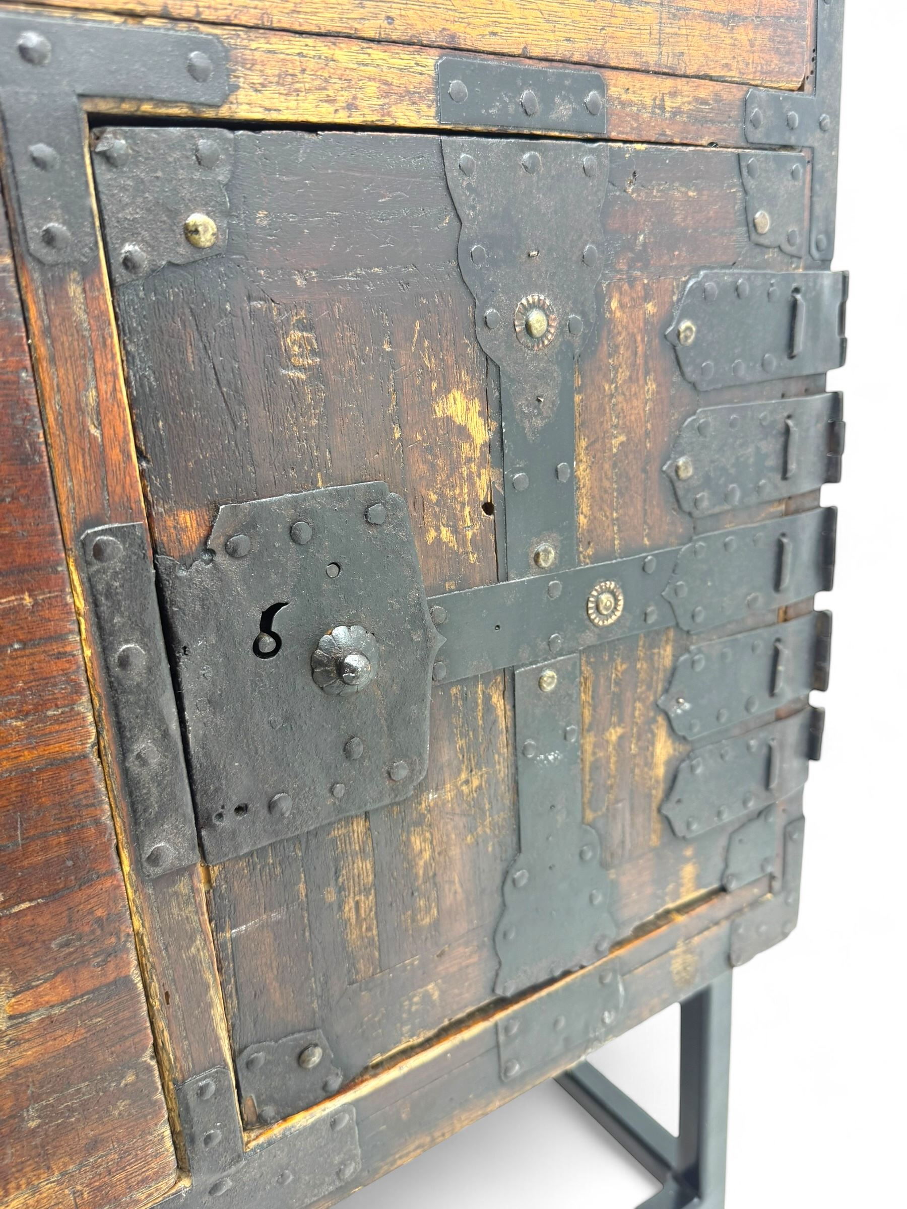 Late 19th century Japanese tansu chest, crafted with a cedar frame and cypress wood panels, original iron fittings throughout, comprising a single long drawer above smaller drawer and hinged cupboard door enclosing two smaller internal drawers and storage compartment, mounted on a bespoke black metal stand