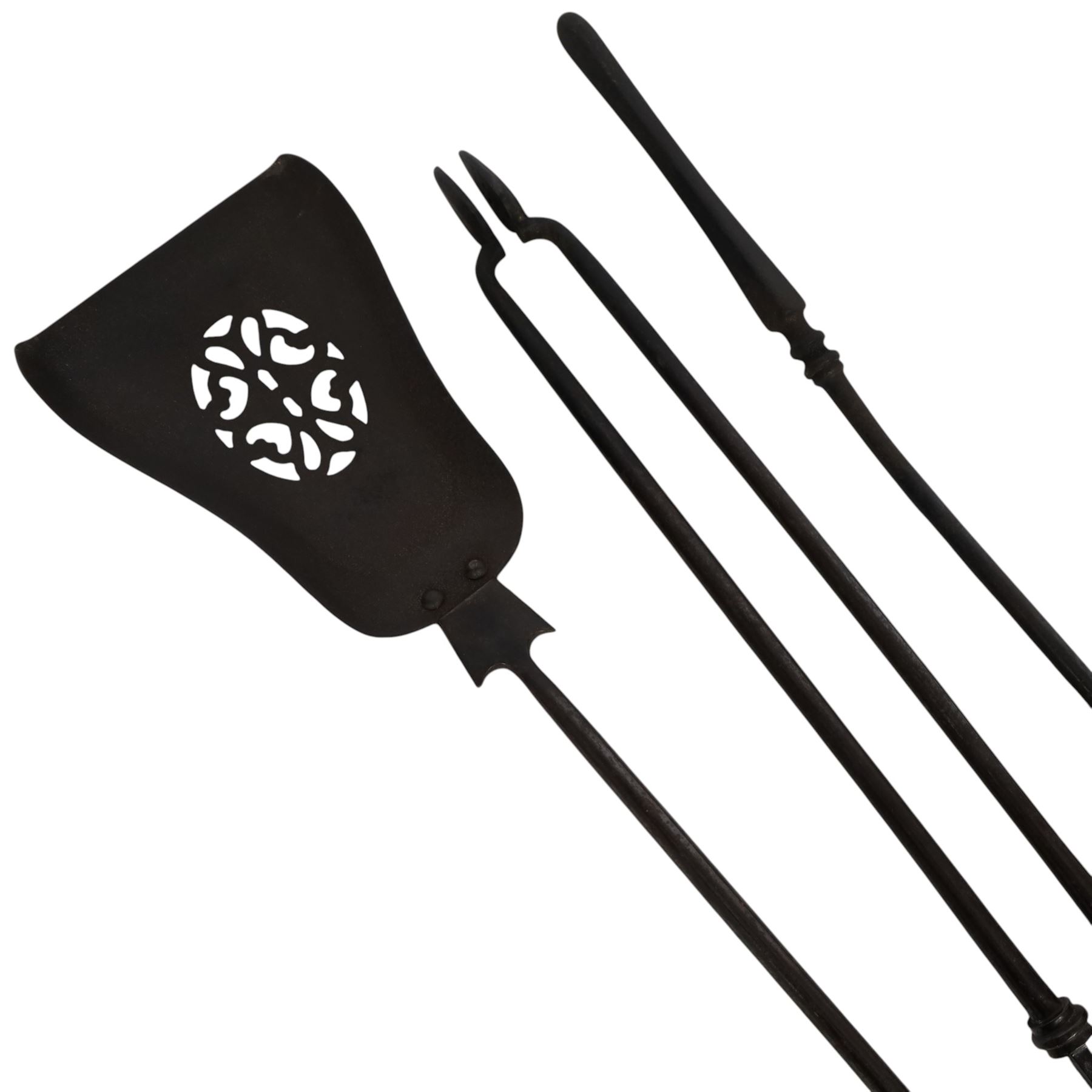 Set of three 19th century brass and steel fire irons, each with tapering and hexagonal capped handles, comprising poker, tongs and shovel with pierced detail, poker L84cm