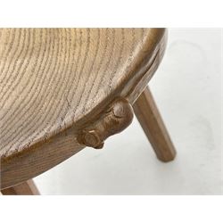 'Mouseman' oak three legged stool with dished kidney shaped seat, tapered octagonal supports, with carved mouse signature, by Robert Thompson of Kilburn 