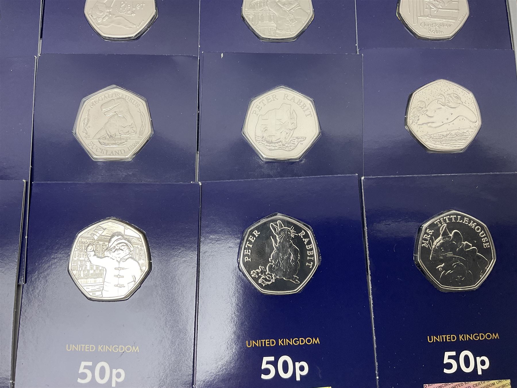 Mostly United Kingdom Queen Elizabeth II commemorative fifty pence coins, including 2019 'Gruffalo', 2020 'Iguanodon', 2022 'The Queen's Jubilee' etc, housed on cards, face value of UK coins approximately 20 GBP