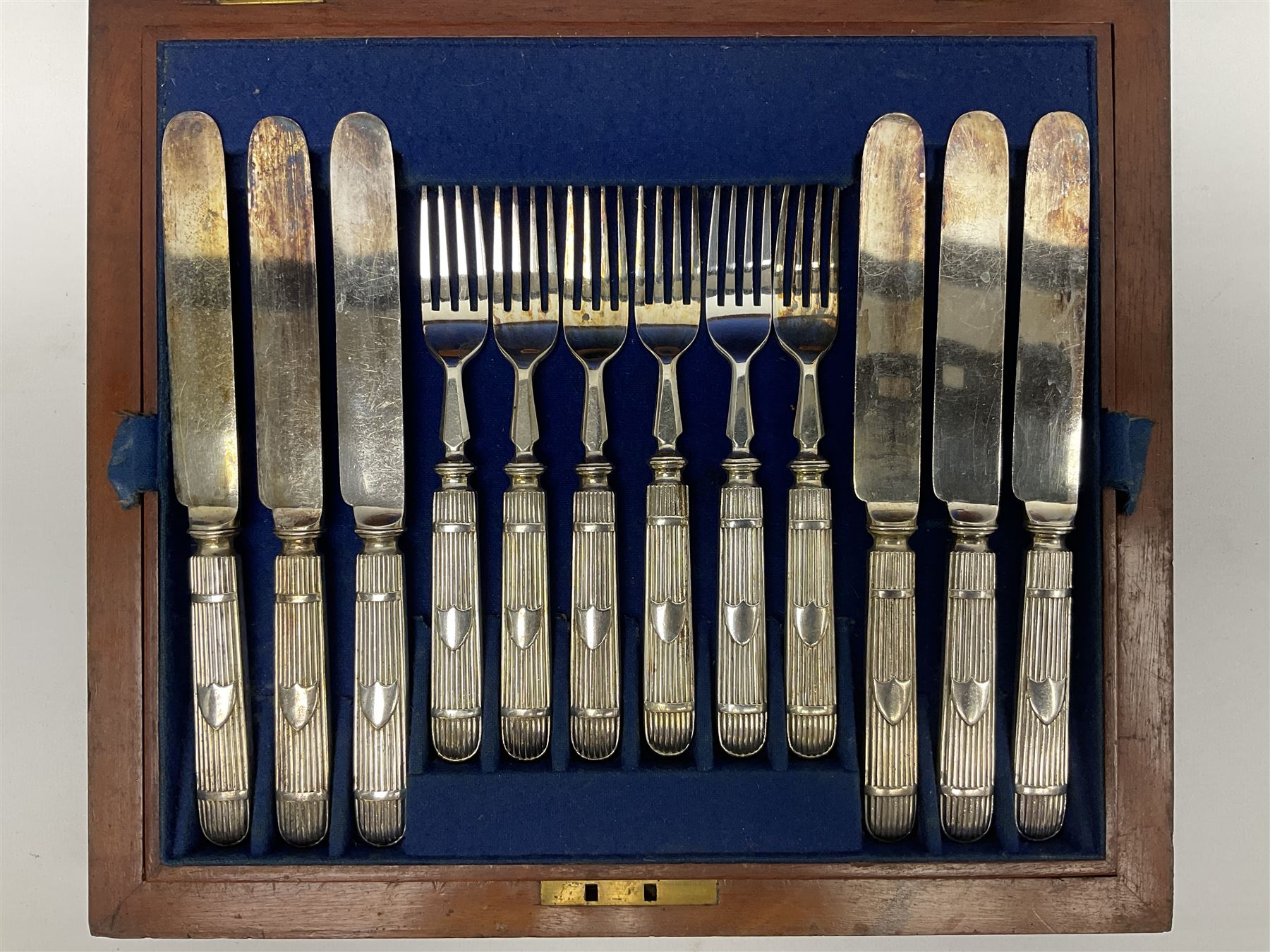 Victorian silver plated dessert set by Elkington & Co for twelve place settings, each reeded handle with vacant cartouche, each with Elkington & Co mark, date letter for 1861, and registration lozenge, contained within a mahogany case with vacant brass cartouche to the hinged cover, opening to reveal a Royal blue baize lined interior with removable tray, case H6cm W29.5cm D26.5cm