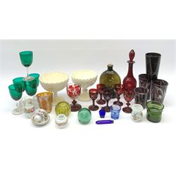 A group of Victorian glassware, to include Ruby flashed decanter and six glasses, decanter H25cm, five further drinking glasses with green bowls, a dump paperweight, and miniature painted milk glass teawares, two slag glass pedestal bowls, four slag glass tumblers, plus a small selection of later glassware, comprising a moulded glass bottle detailed 'Success to the Railroad', and an amber glass Isle of Man 1892 exhibition compressed tumbler. 