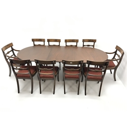  Regency Style mahogany twin pedestal dining table, turned columns on reeded sabre supports brass capped on castors (W234cm, H71cm, D98cm) and set of ten (8+2) mahogany dining chairs, upholstered seat, G.T.Rackstraw (W52cm)  
