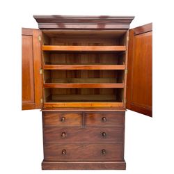 Victorian mahogany linen press, projecting moulded cornice, two doors with arched panels enclosed four linen slides, the lower section fitted with two short and two long drawers, on plinth base