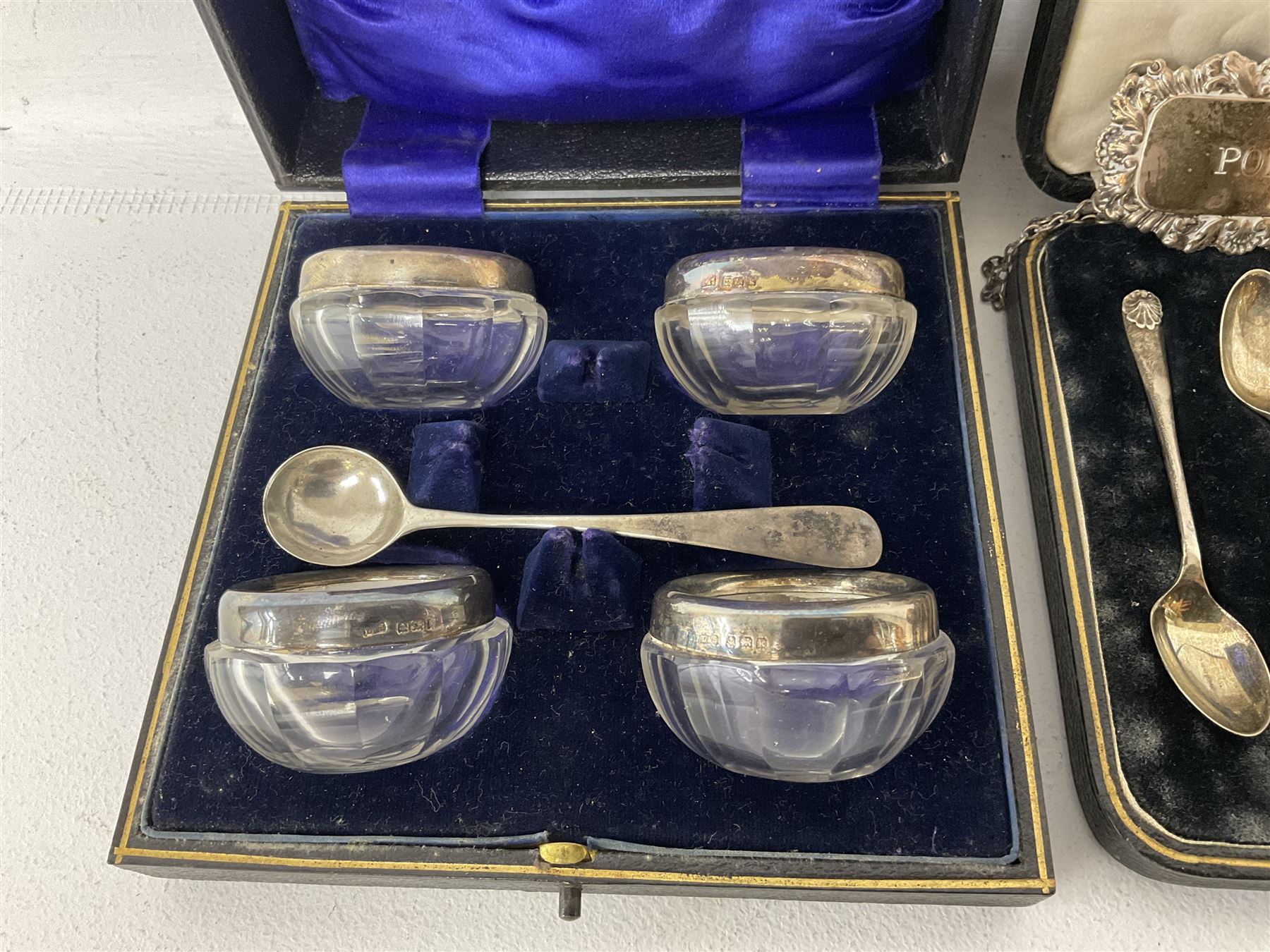 Cased set of six spoons by Cooper Brothers & Sons, two hallmarked silver decanter labels, four silver collared glass salts in box, further silver spoon and napkin ring