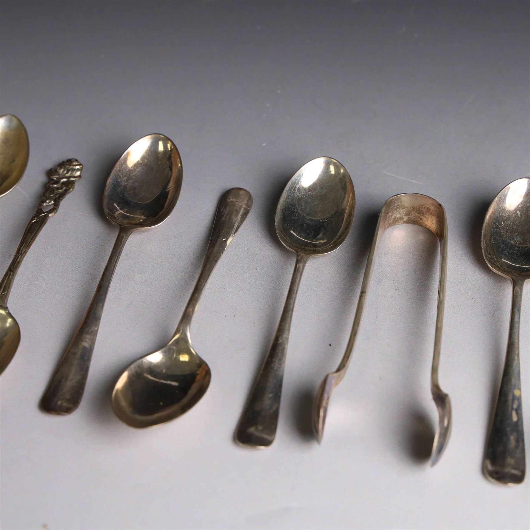 Set of six continental 800 silver coffee spoons with pierced rose design finials, stamped 800 verso, together with a cased set of six teaspoons and sugar tongs, with rattail bowls and engraved initials verso, hallmarked Cooper Brothers & Sons Ltd, Sheffield 1912, 