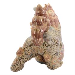 Temple Lion or Dog of Foo, modelled in seated post, one with one front paw resting upon a ball, with sword in mouth, H58cm