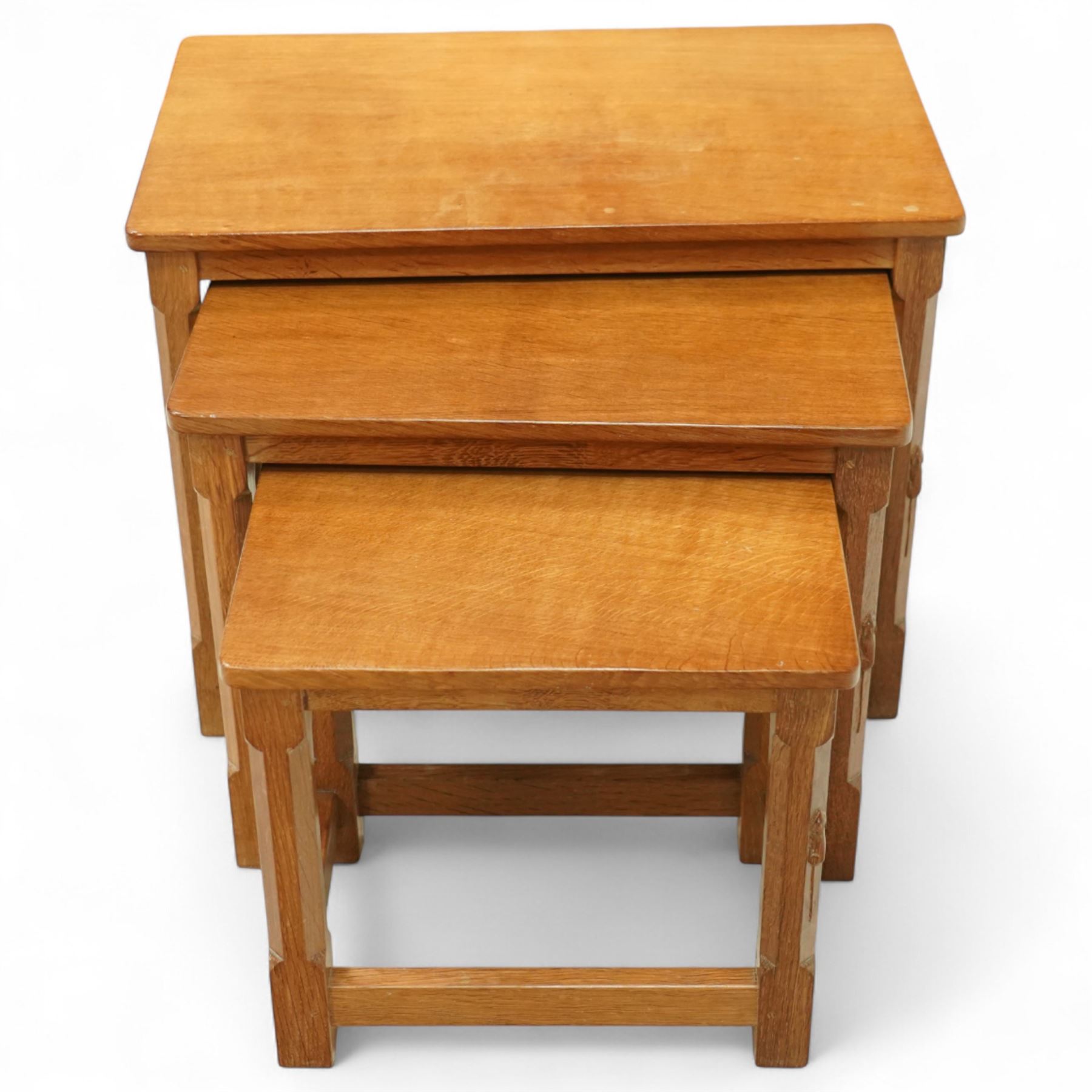Mouseman - nest of three oak occasional tables, rectangular adzed top, on octagonal supports united by plain stretchers, each carved with mouse signature, by the workshop of Robert Thompson, Kilburn