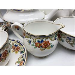 Royal Albert tea service for six, decorated with orange and yellow flowers with blue borders, gilt edging, comprising six teacups and saucers, six side plates, open sucrier and jug, teapot and hot water pot