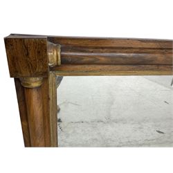 Early 19th century rosewood overmantel mirror, rectangular form with turned half pilasters, moulded gilt slip enclosing plain mirror plate, on turned feet