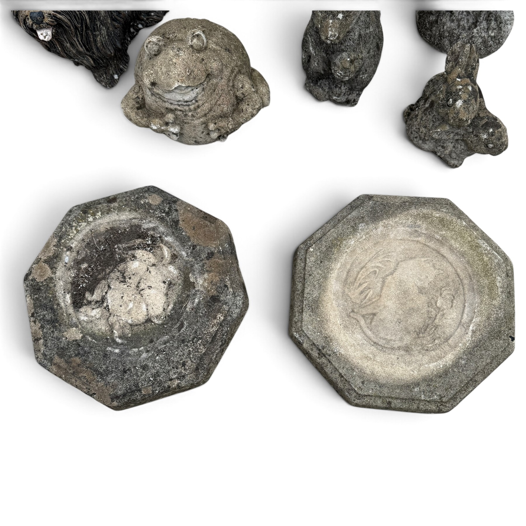 Assorted cast stone garden ornaments, comprising putto bird bath (W43cm H72cm), owl, dog, frog, rabbit and two squirrel figures, with two octagonal relief-moulded stepping stones, one decorated with central cat motif