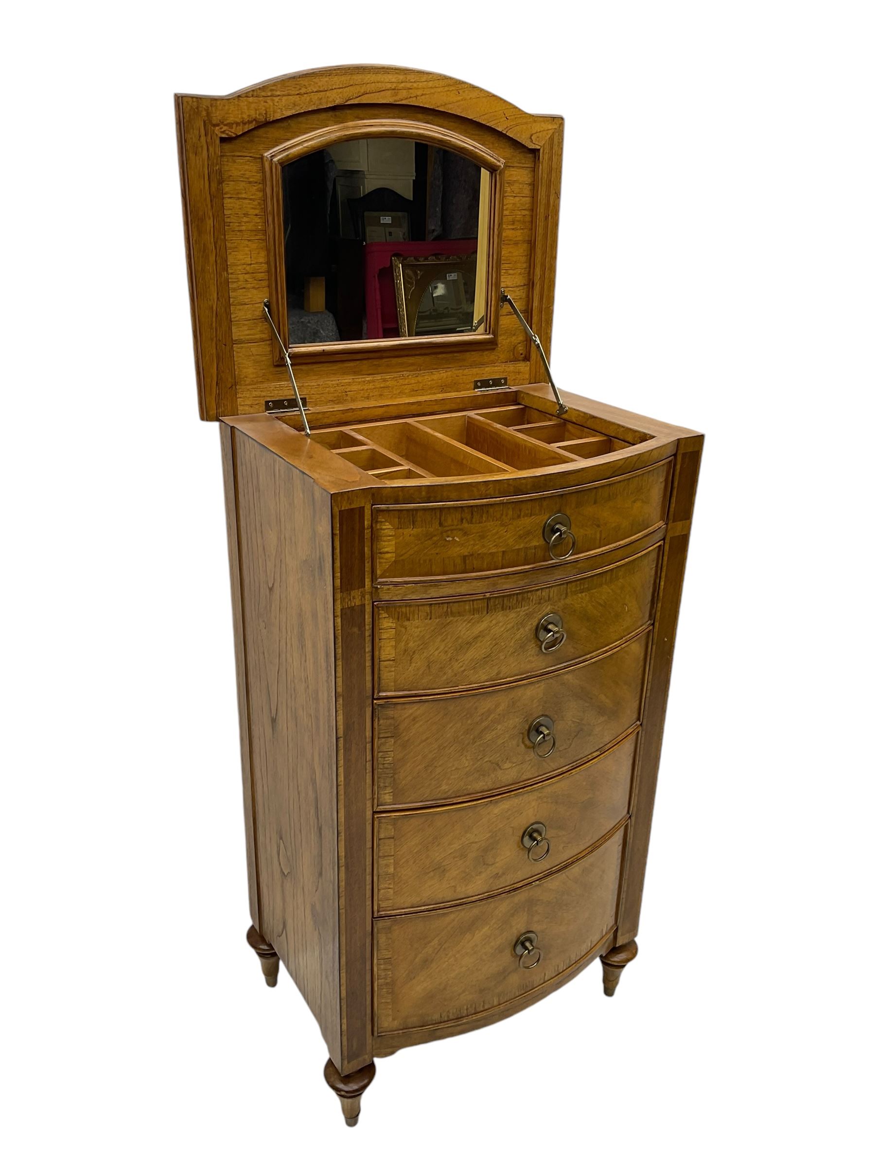 Frank Hudson - mid-20th century Mindi ash and burr walnut bow-fronted lingerie chest, crossbanded hinged top concealing vanity mirror, over five graduated cockbeaded drawers, raised on turned supports