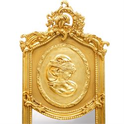 Pair of Rococo Revival gilt framed wall mirrors, the pierced scrolling rocaille pediment with foliate motifs over an oval panel with relief portraits of classically draped females, over a shaped rectangular bevelled plate surrounded by beading and scrolling foliate motifs