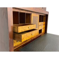 Early to mid-19th century figured mahogany Continental secrétaire à abattant, stepped top fitted with single cupboard, inlaid with oval figured amboyna panels, the fall front inlaid with shell motif enclosing a satinwood interior fitted with cupboard, drawers, and pigeon holes, three long drawers below, on square tapering feet