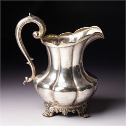 Victorian silver cream jug of panel sided baluster form with crimped rimand scroll handle on shaped supports London 1840 Maker Charles Gordon  