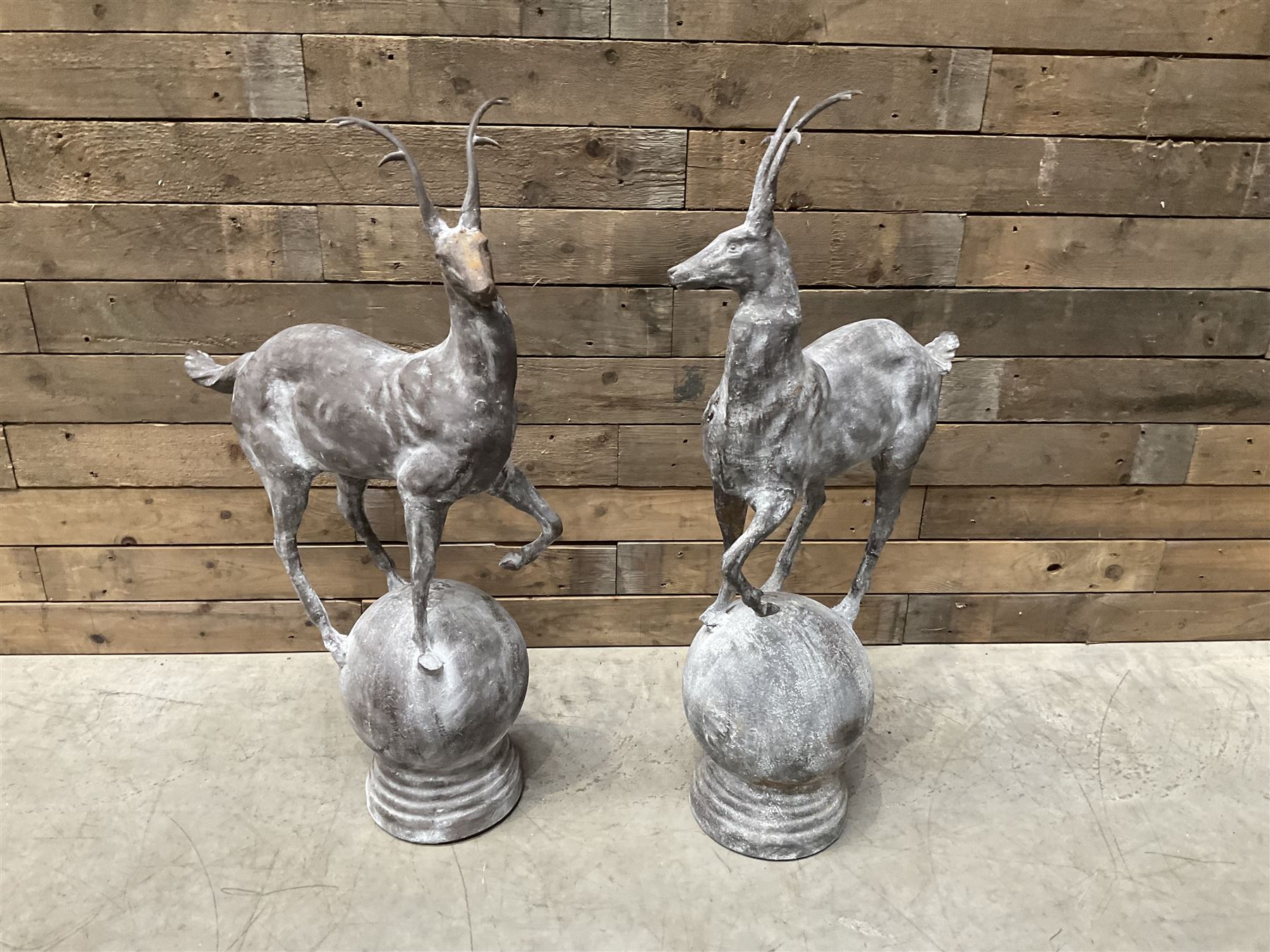 Pair of cast iron garden Stag figures or gate finials, raised on spherical ribbed base 