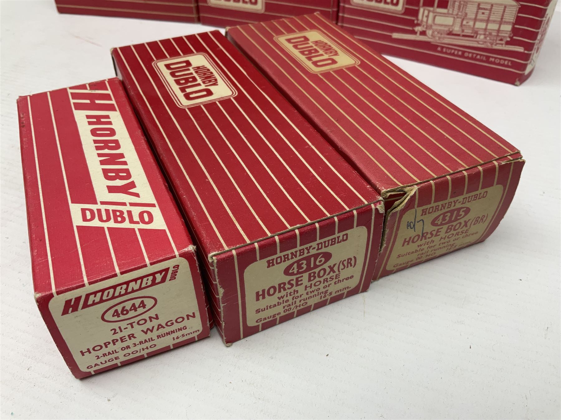 Hornby Dublo - sixteen goods wagons comprising 4644 21-Ton Hopper Wagon, 4315 Horse Box (BR) with horse, 4316 Horse Box (SR) with horse, 4649 Low Sided Wagon with tractor, 4301, 4310, 4311, 4312, 4313, 4320, 4626, 4648, 4652, 4675, 4678 and B550200 (Mineral Wagon); all in red boxes (16)