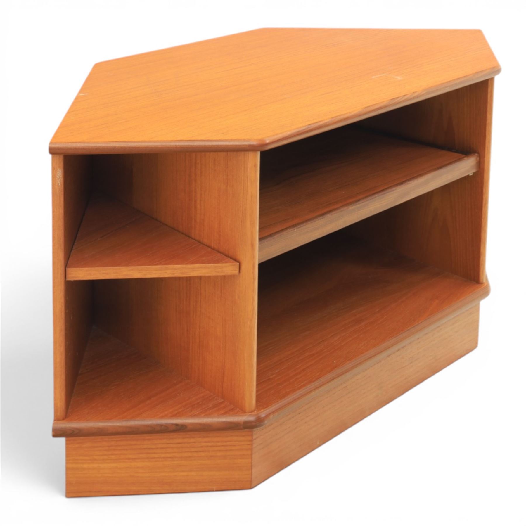 G-Plan - teak corner media unit, shaped top above a sliding central shelf above an open recess, flanked by further shelves, raised on a plinth base with a rear aperture for wires
