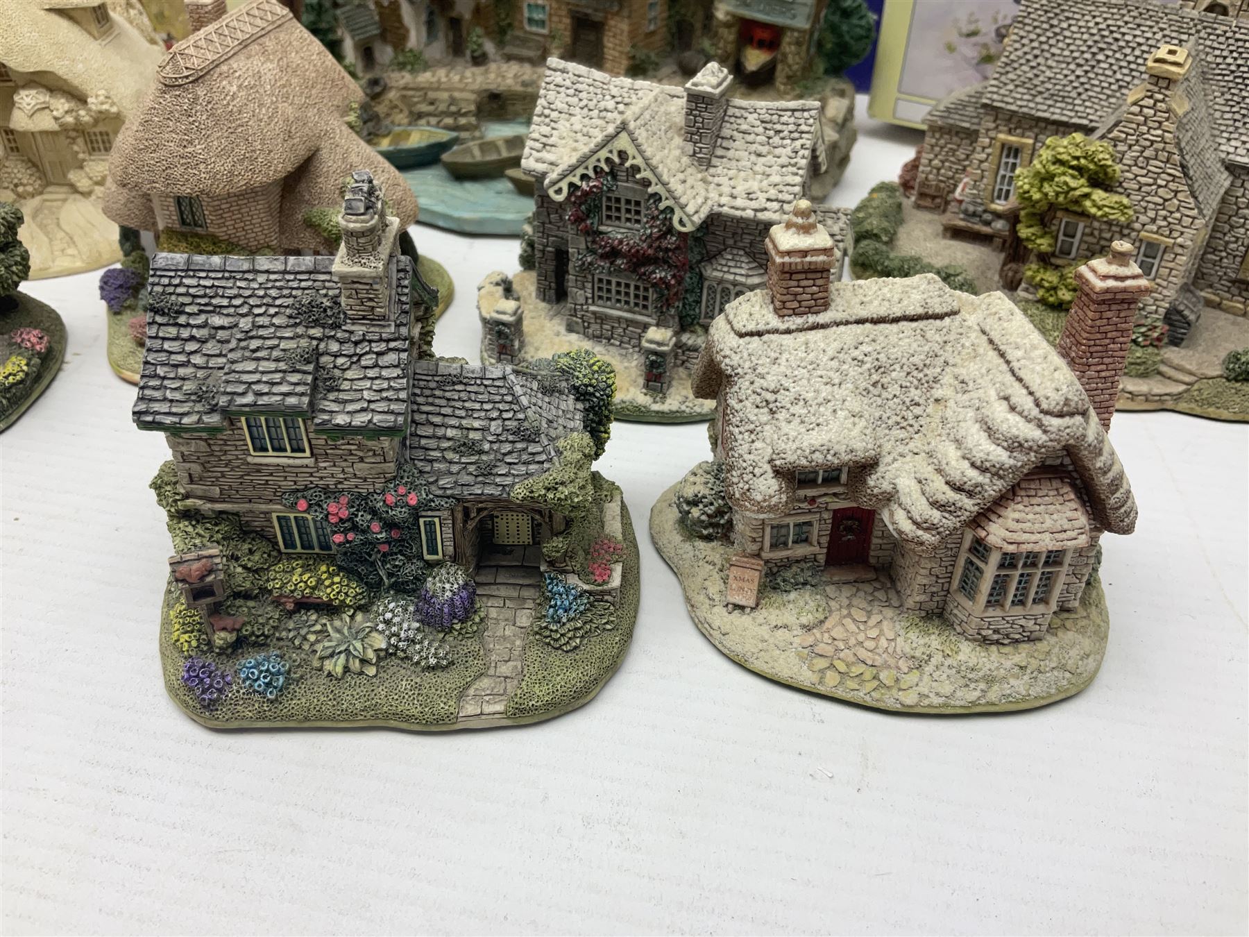 Twenty three Lilliput Lanes, including Village School, Lace's Shoe Shop, Cockles & Muscles, Scotland the Brave etc, together with The Leonardo Collection Paint Box Poppets and Gullivers World magazines 