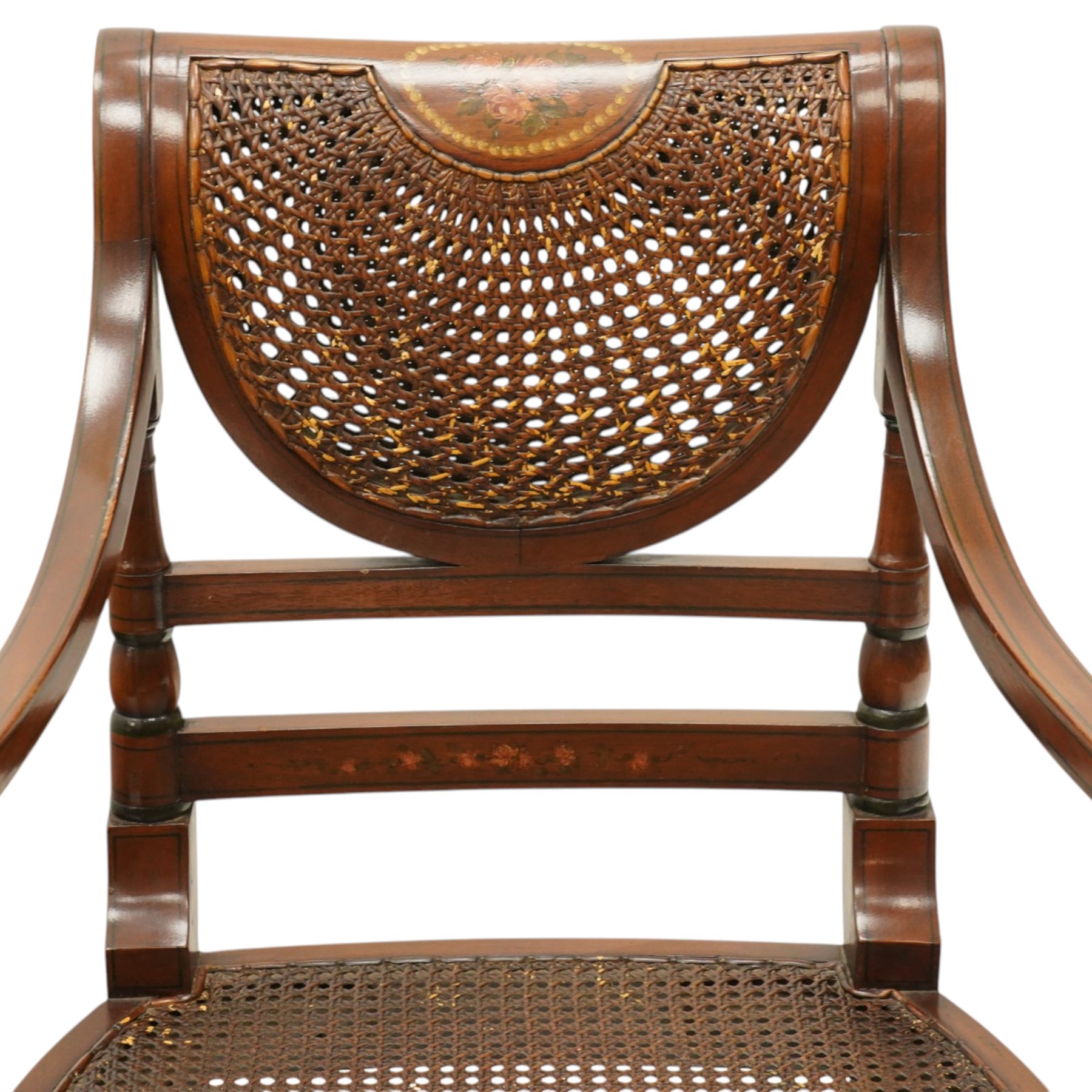 Pair of Sheraton Revival painted mahogany open armchairs, scrolled cresting rail with floral painted decoration over a double-caned back and rose-branch painted back bar, cane seat over C-scroll-painted seat rail, on splayed tapering supports, with all-over painted ebony faux stringing