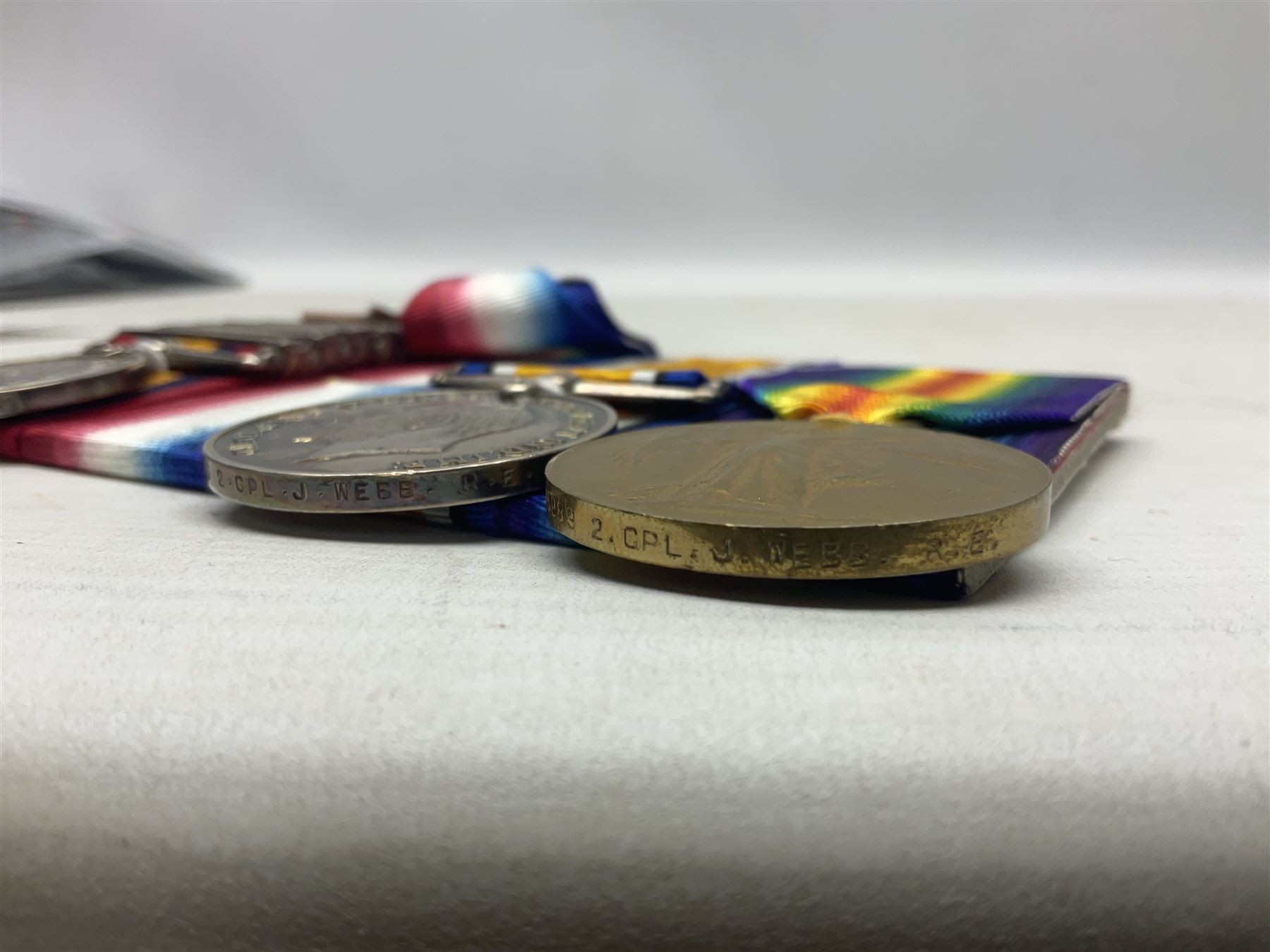 Boer War/WW1 group of four medals comprising Queens South Africa Medal with five clasps for South Africa 1901 & 1902, Transvaal. Orange Free State and Cape Colony awarded to 8321 Sapper J. Webb Rl. Engrs.; together with British War Medal, 1914-15 Star and Victory Medal awarded to 46989 2.Cpl. J. Webb R.E.; all with ribbons and mounted for display on card; some biographical details