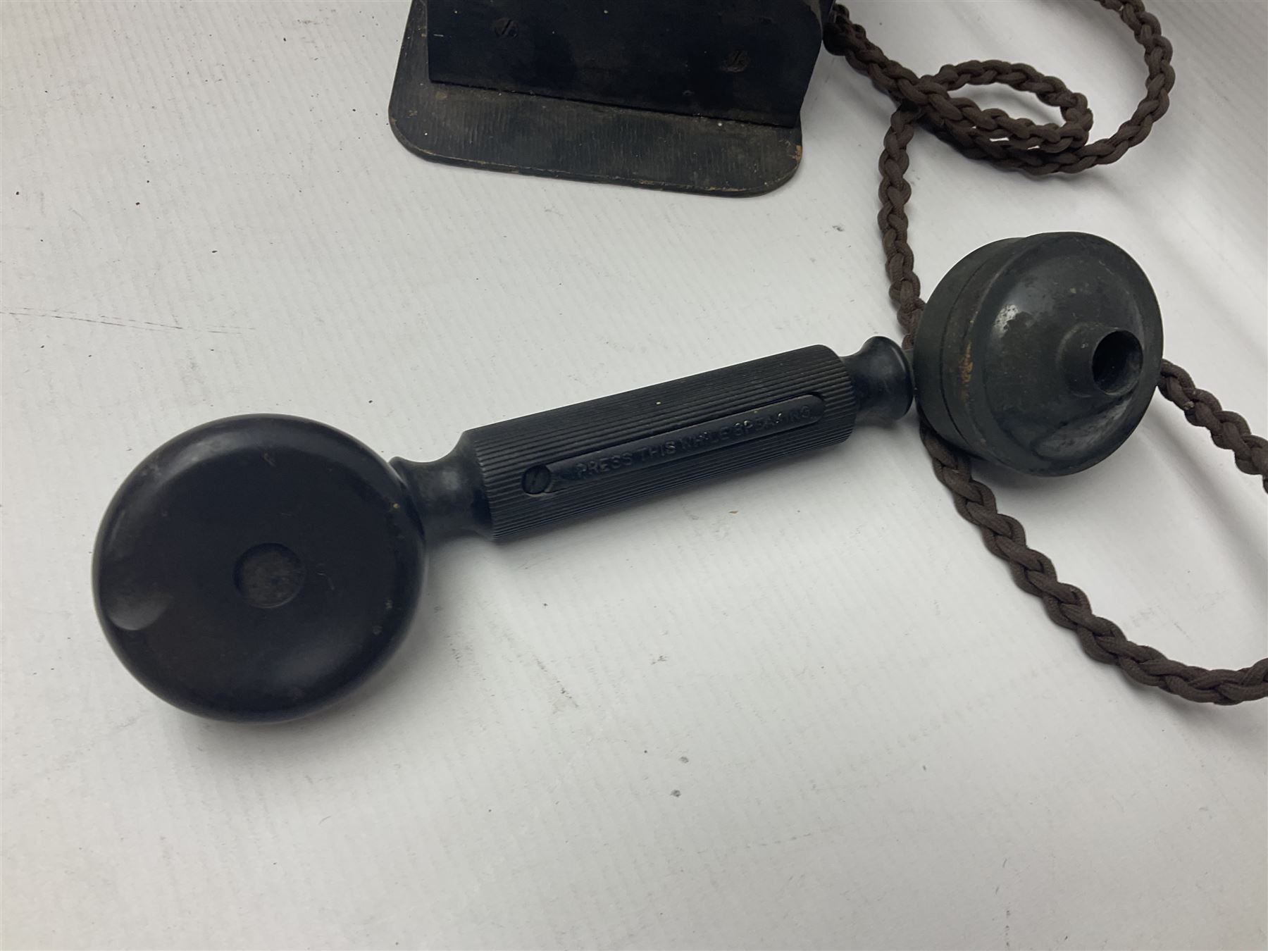 Collection of phone headsets, including GPO bakelite examples, together with other telephone parts 