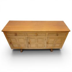Beaverman - 1980s adzed oak sideboard raised on a trestle base, three drawers over three cupboards with Yorkshire Rose carved handles, fielded panelled sides and front, with carved Beaver, by Colin Almack of Sutton near Thirsk