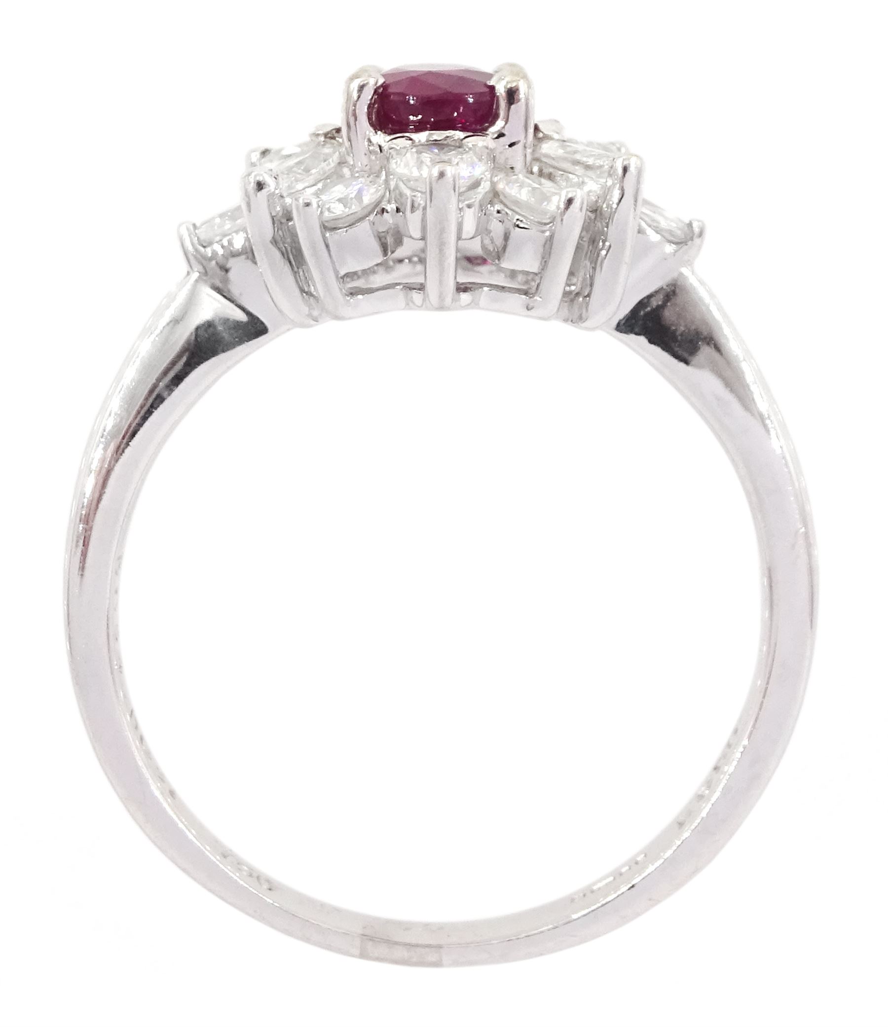 18ct white gold ruby and diamond cluster ring, the oval cut ruby of 0.86 carat, with marquise cut and round brilliant cut diamond surround, London 2004, total diamond weight 0.65 carat 