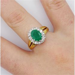 18ct gold oval emerald and round brilliant cut diamond cluster ring, London 1979