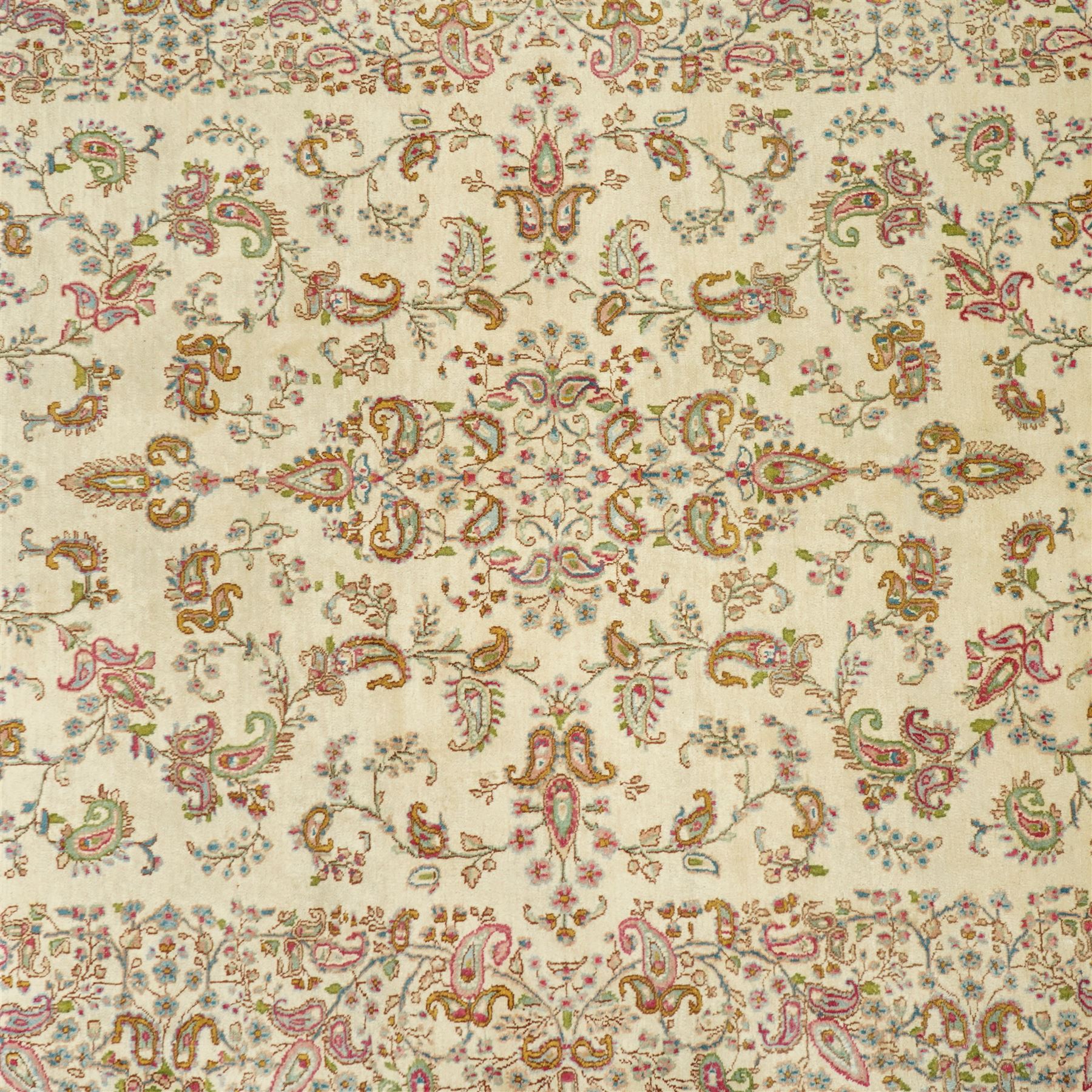 Persian Isfahan cream ground rug, overall floral design, sparse field decoration with trailing flower head and Boteh motifs, repeating floral pattern boarder with repeating motifs 
