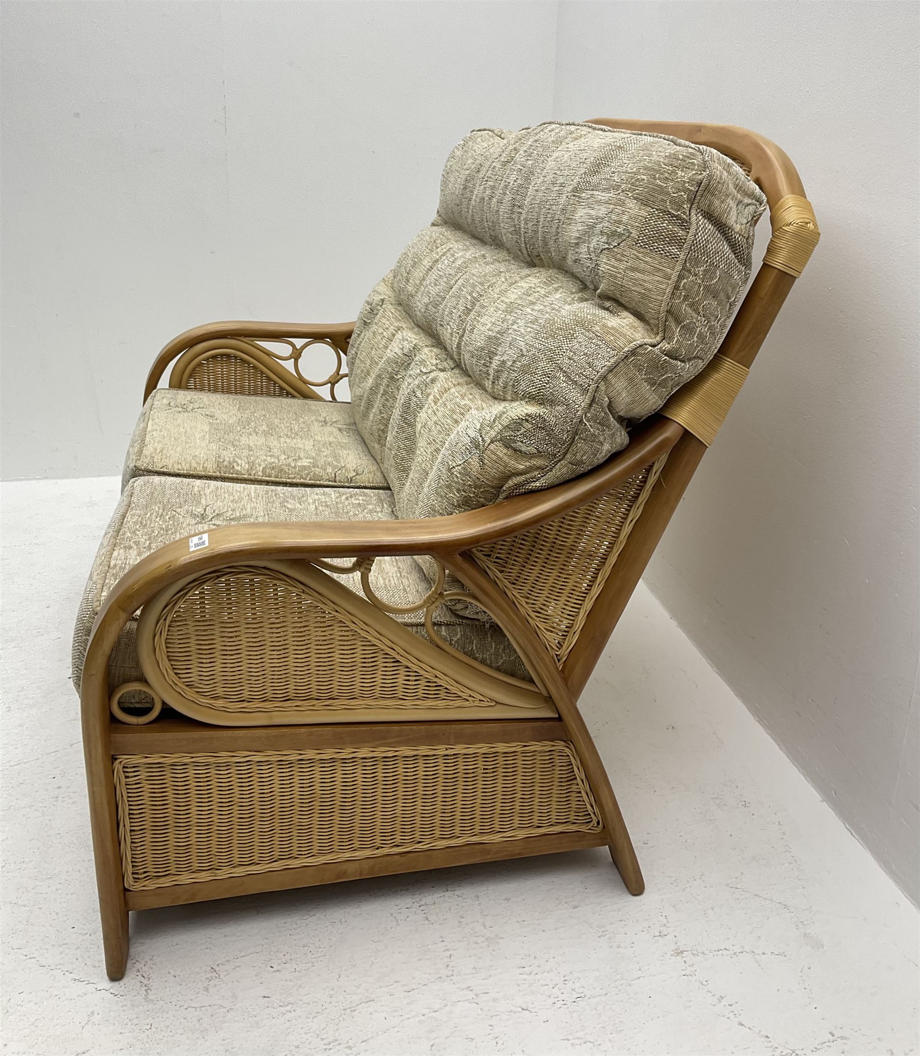 Light wood and cane two seat conservatory sofa, loose beige patterned cushions