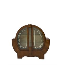 Art Deco walnut display cabinet, of circular design, fitted with two shaped glazed doors enclosing two glass shelves, flanking five glass rods