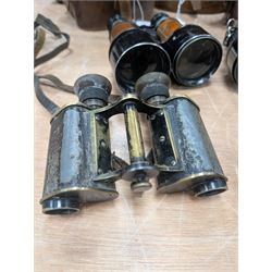 Four pairs of early 20th century binoculars, including Carl Zeiss Jena Feldstecher binoculars, Carl Zeiss Telact 8x binoculars, Dollond x5 field binolculars and one other pair, all in leather cases, one case marked with broad arrow, some with officers name etched