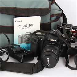 Canon AE-1 camera body, serial no. 3484113, with a Canon Zoom Lens FD 35-70mm 1:4, serial no. 103833, together with a Canon EOS 30D camera body, serial no. 1230810818, with a   Canon Zoom Lens EF-S 18-55mm 1:3.5-5.6 II, serial no. 2140596539, in Tuf Foto Pro carry case, with accessories 