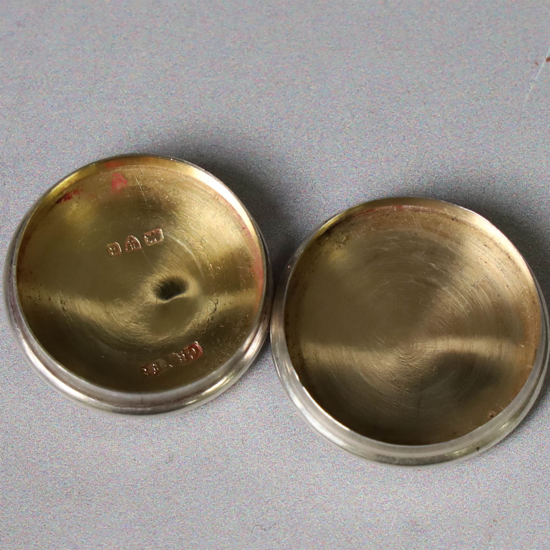 Two early 20th century silver pill/patch boxes, together with two glass perfume bottles with silver overlay and stoppers, all stamped or hallmarked, smallest box D2cm, largest bottle H7cm