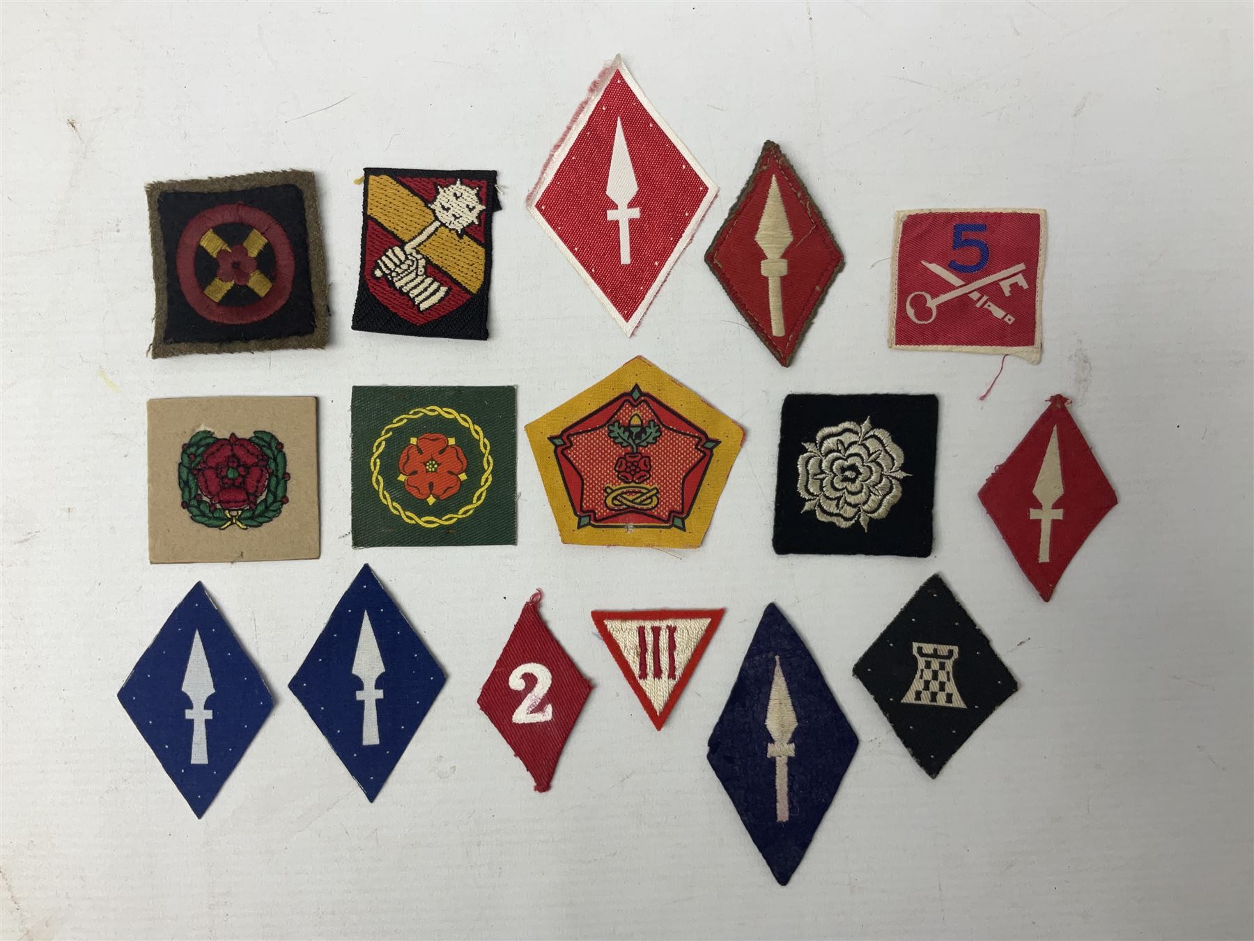 Approximately one-hundred printed and embroidered cloth badges including I, II, VIII, XI, XII and XXX Corps, Eastern Command, various Armoured Divisions, Midland, Wessex, Home Counties and 12th Infantry Brigades, Salisbury Plain, Northumberland, Hampshire, North Midland, West Riding, Essex and Suffolk Districts, Berlin & Rhine Army Troops etc