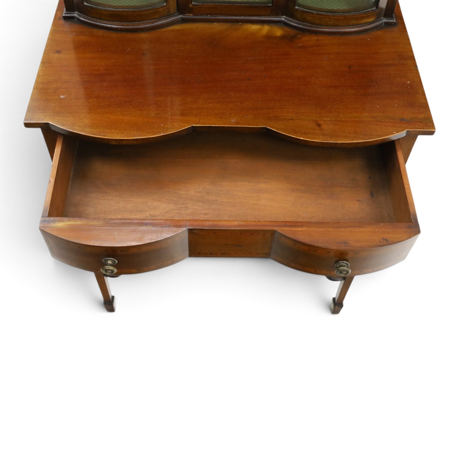 Edwardian inlaid mahogany serpentine-front side cabinet, raised back with central glazed door flanked by bow-front glass panels, the base fitted with banded and shaped frieze drawer, on square tapering supports united by concave under-tier