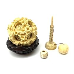 A Chinese carved ivory puzzle ball, with 9 concentric layers an carved with dragons (lacking base), together with an ivory games ball, on stand (a/f).